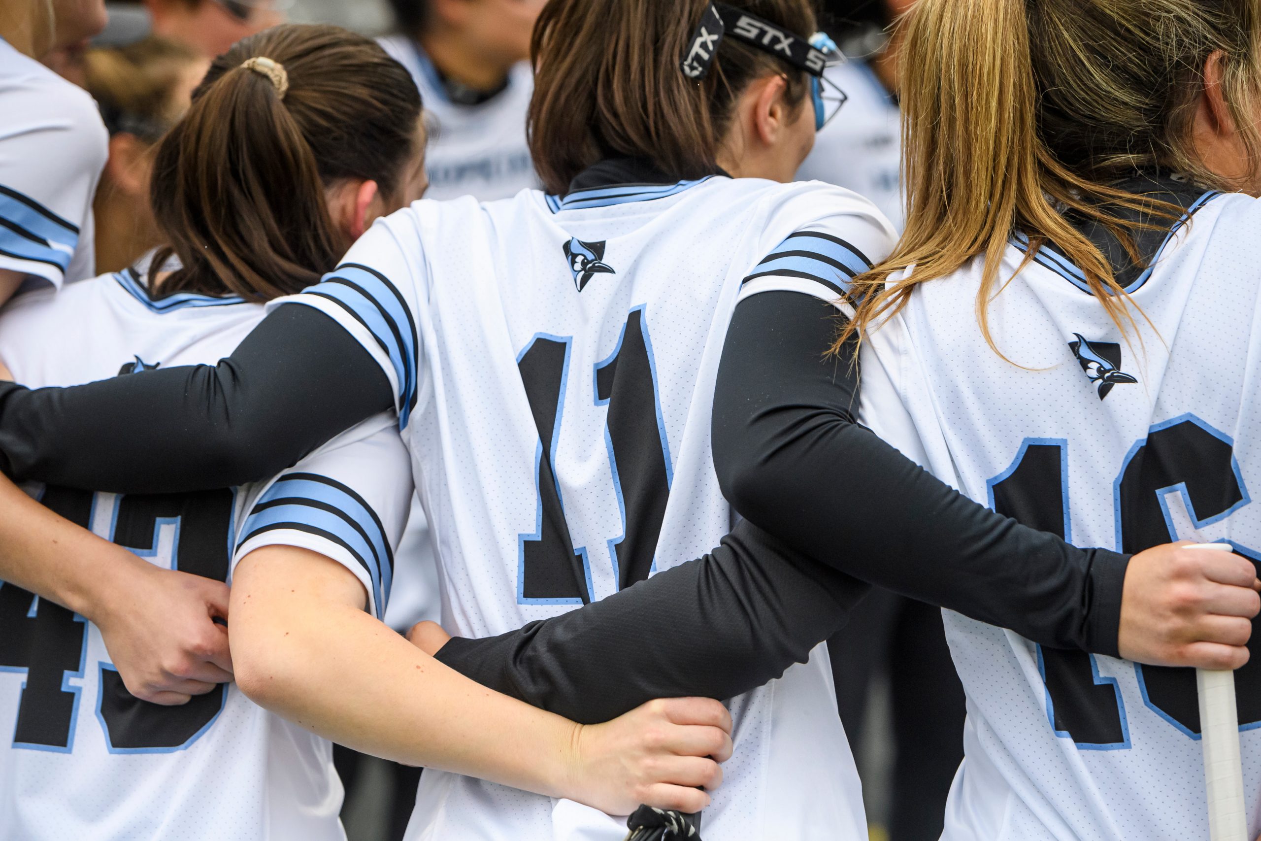 Women's lacrosse team huddled during a game