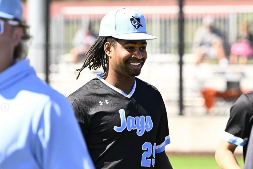 Baseball player wearing a jersey with "Jays" hand lettering graphic