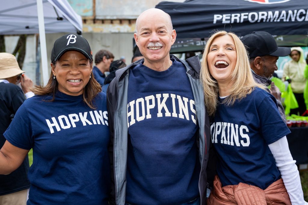 3 members of Hopkins leadership wearing matching navy blue shirts that say "Hopkins"