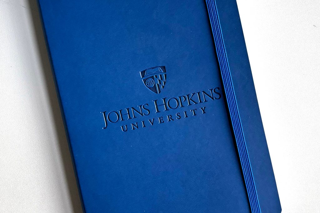 Johns Hopkins logo debossed on a notebook