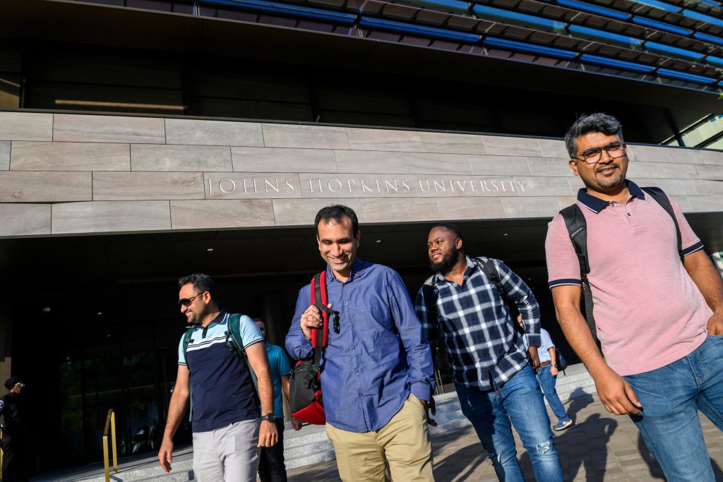 Group of students walking outside the Hopkins Bloomberg Center in Washington, D.C.