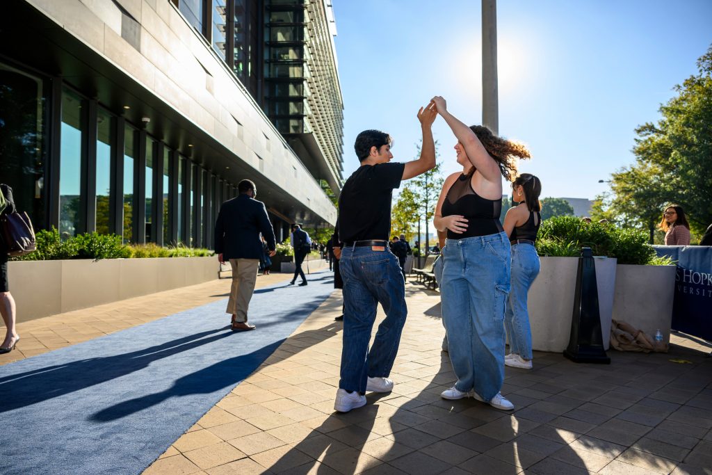 Two Peabody students performing dance outside of Hopkins Bloomberg Center in Washington, D.C.