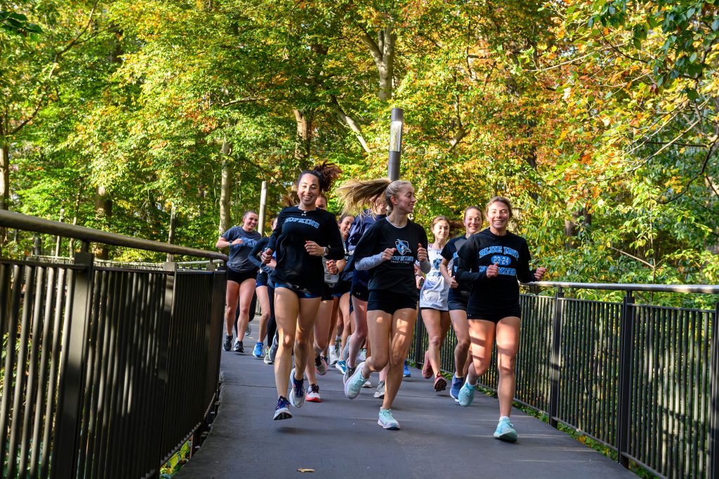 Female student athletes running on Homewood Campus