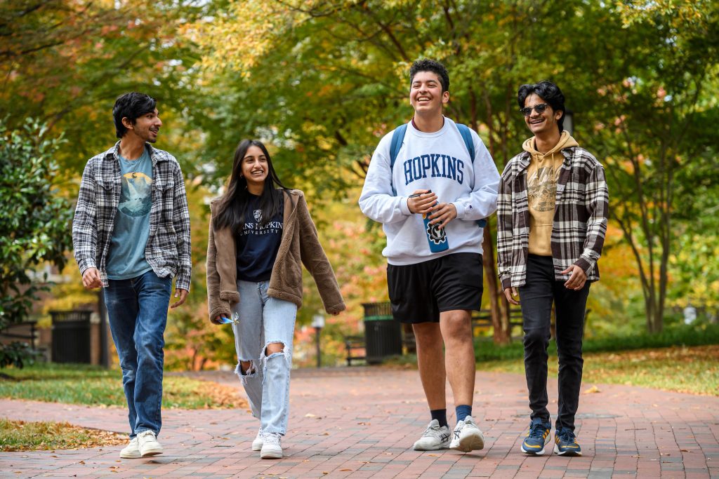 Group of students walking on the Homewood Campus