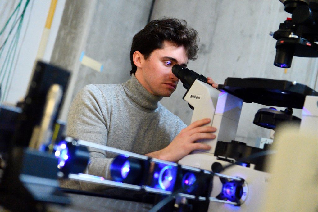 Student looking into microscope