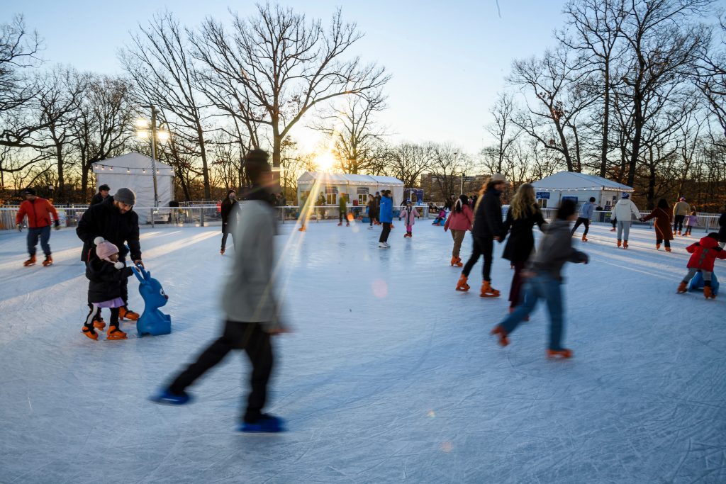 Motion blurred image of people skating on the Hopkins pop-up ice rink