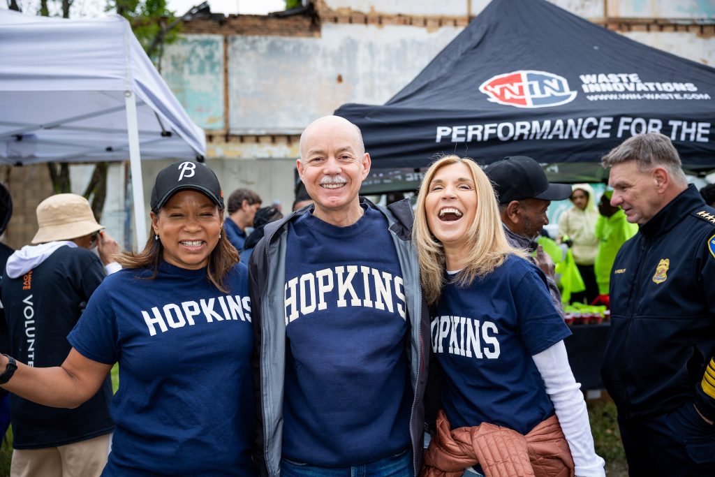 Volunteers wearing Hopkins t-shirts at a city clean-up event