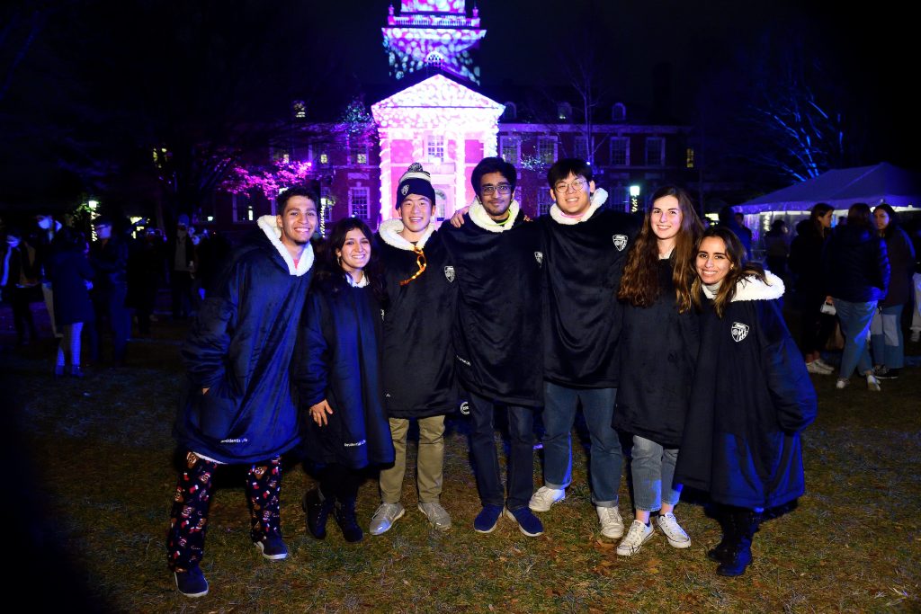 Group of students wearing JHU-branded snuggies at Lighting of the Quads