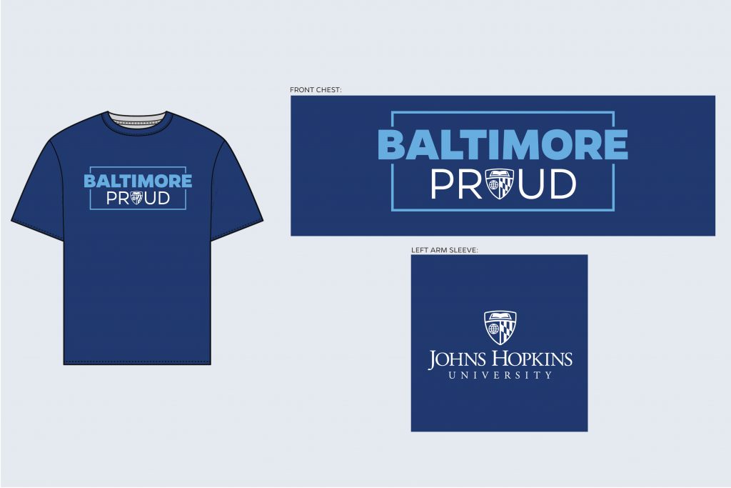 T-shirt mockup with "Baltimore Proud" on the front chest and the primary Johns Hopkins logo on the sleeve.