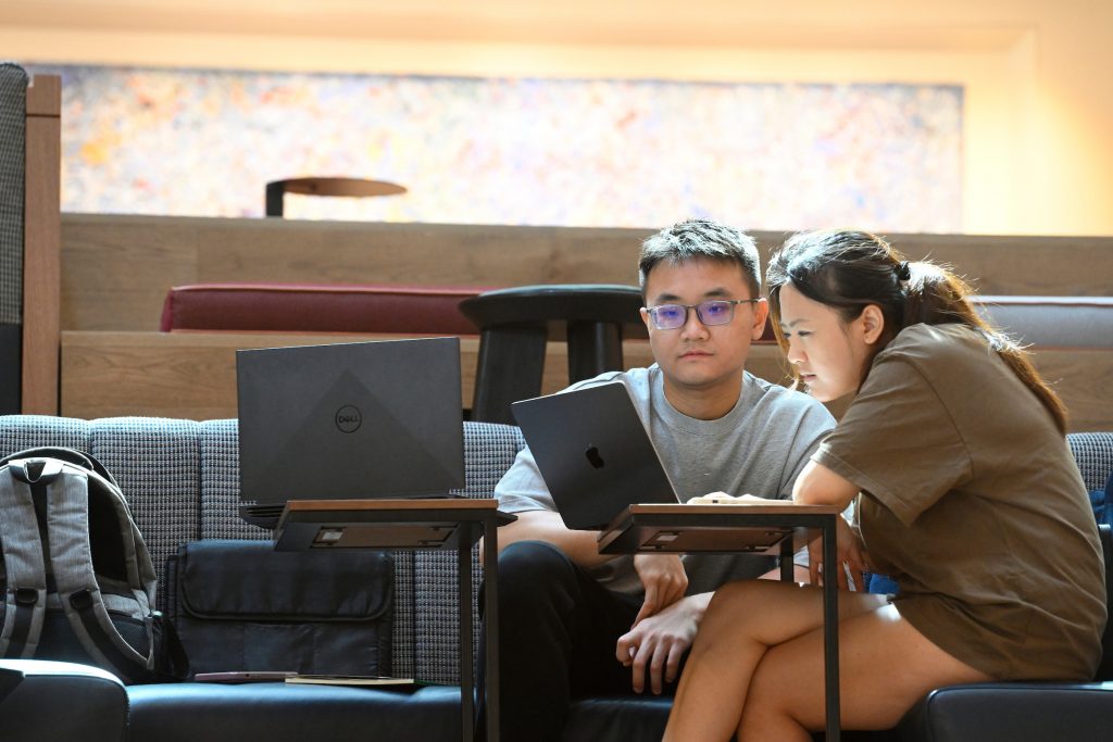 Two students working on laptops