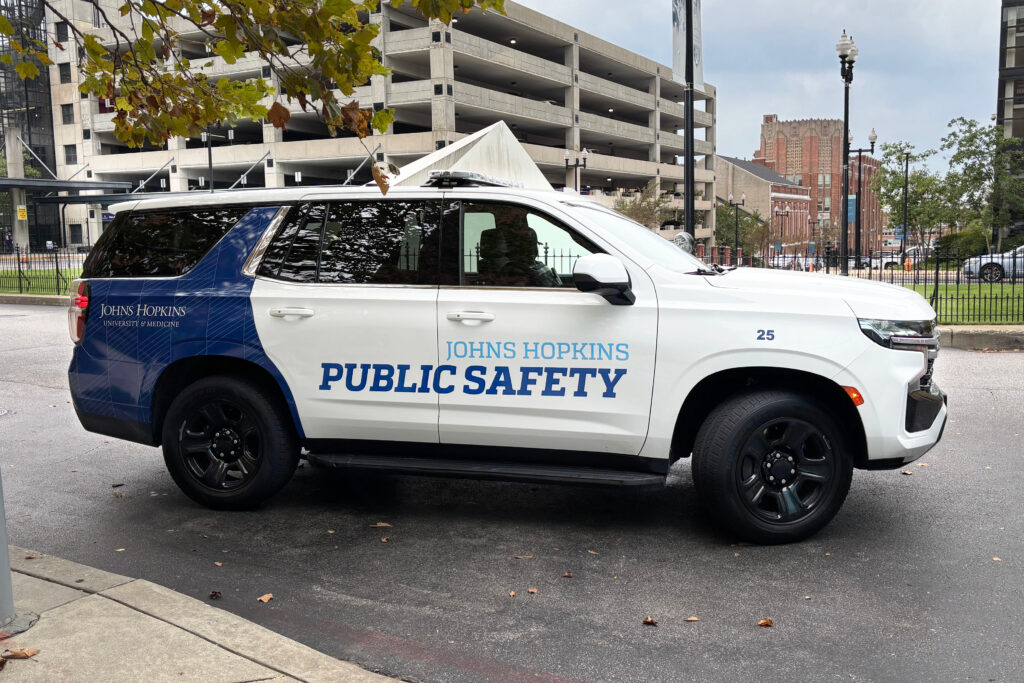 Johns Hopkins polic car with community pattern applied painted on side panel.