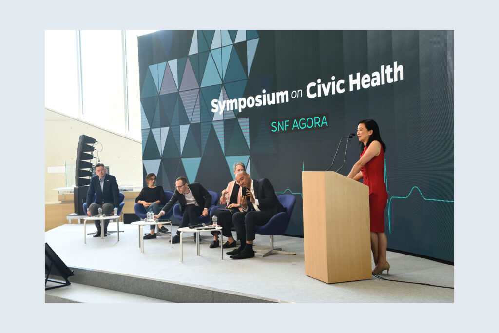 SNF Agora panel with patterned backdrop